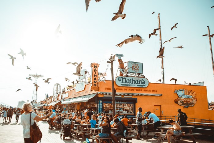 Nathan's Famous restaurant with seagulls flying