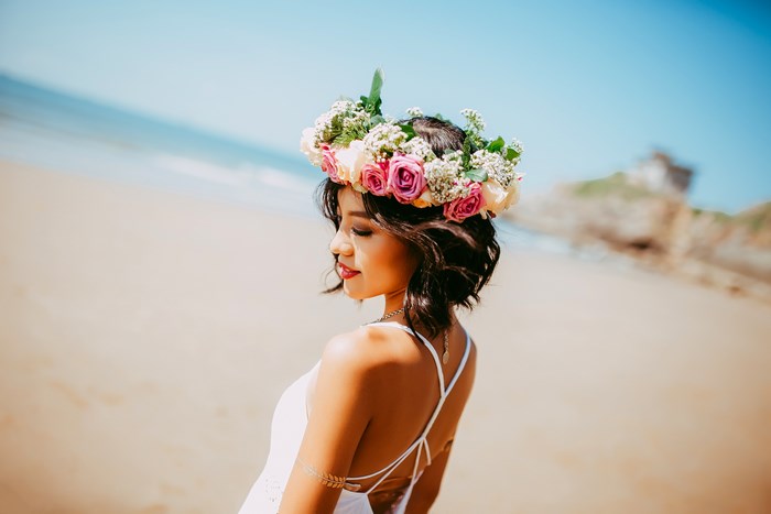 Young Asian woman with flower crown on beach