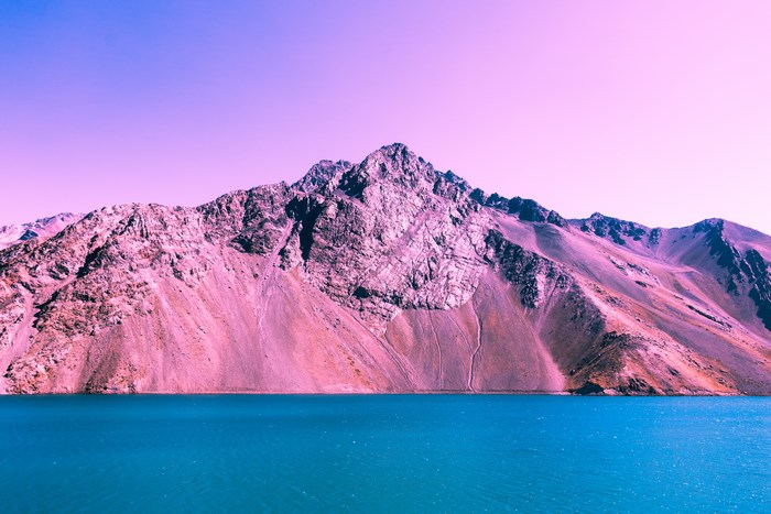 Purple and pink mountains overlooking a blue lake