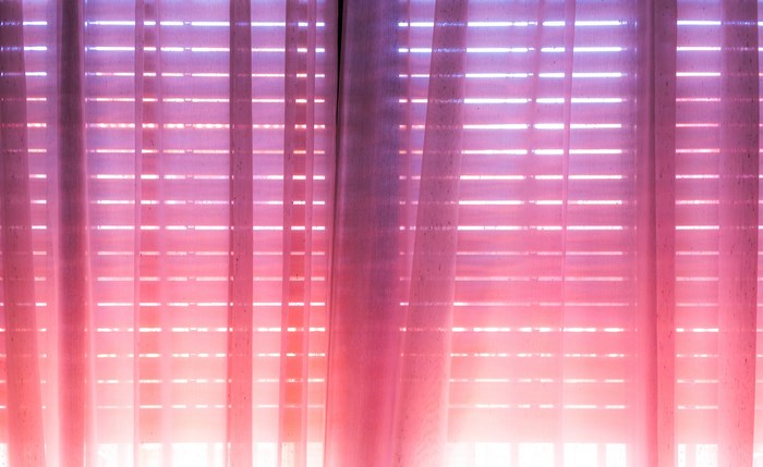 Sunlit Pink Curtains and Shuttered Window in Spain