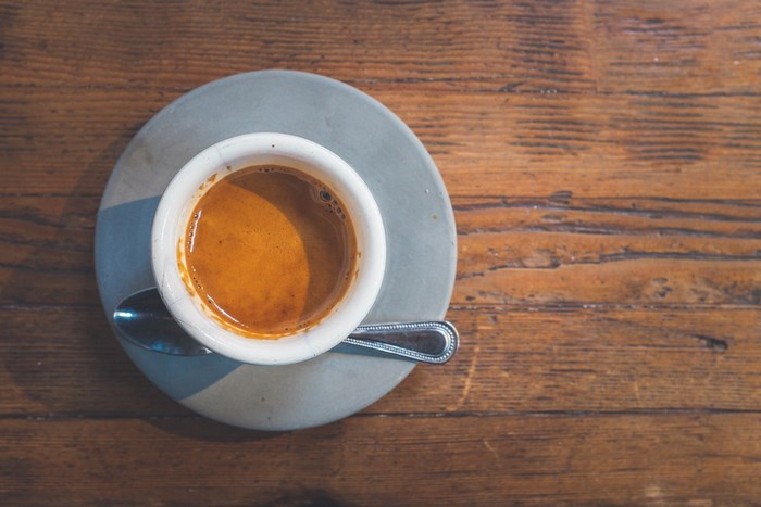 Espresso cup with spoon on a wooden table