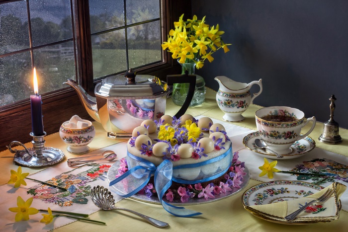 Elegant Tea Setting with Floral Cake and Candlelight