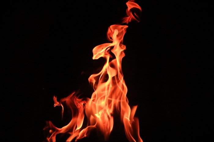Orange flames burning against a black background