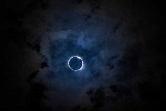 Solar eclipse with clouds at night