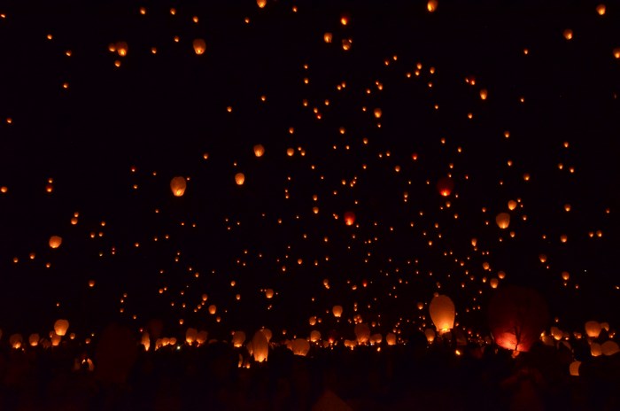 Night sky filled with glowing paper lanterns