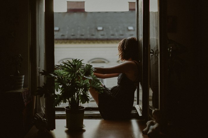 Woman sitting by the window in Ljubljana