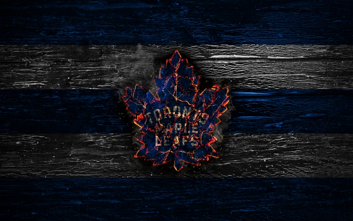 Toronto Maple Leafs logo on a wooden background