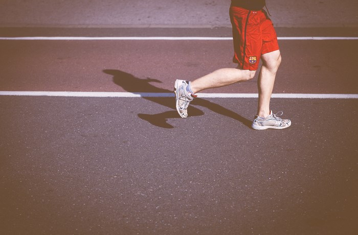 Runner in red shorts on a track