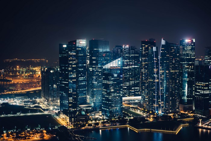 Nighttime Metropolitan Cityscape Along Waterfront