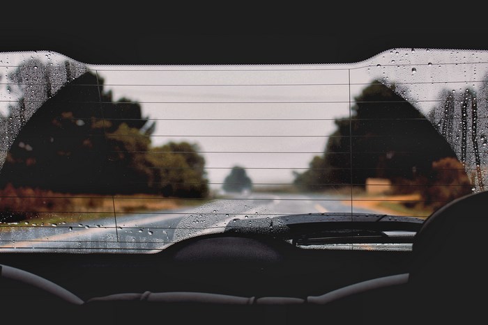 View through a car window on a rainy road trip
