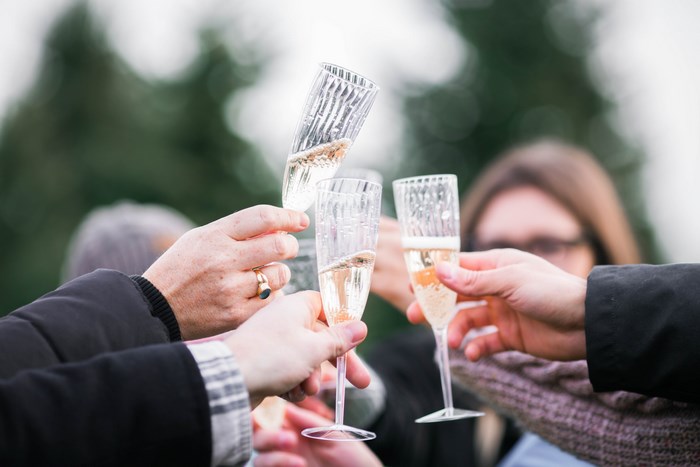 People toasting with champagne glasses