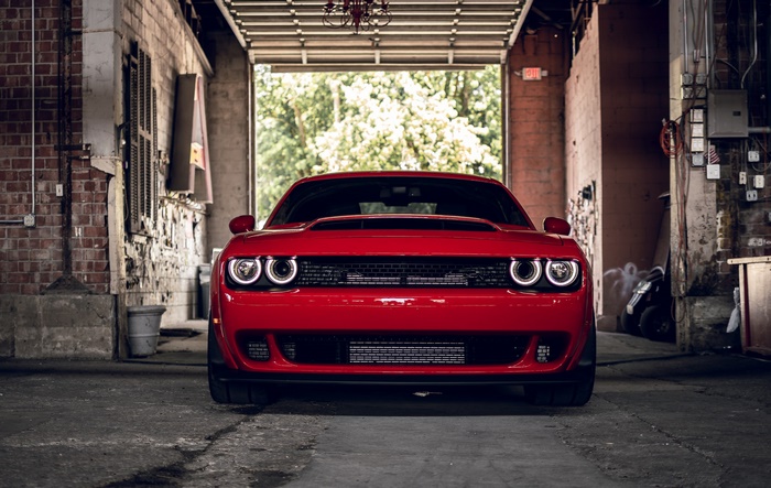 Red Dodge Challenger parked in a garage