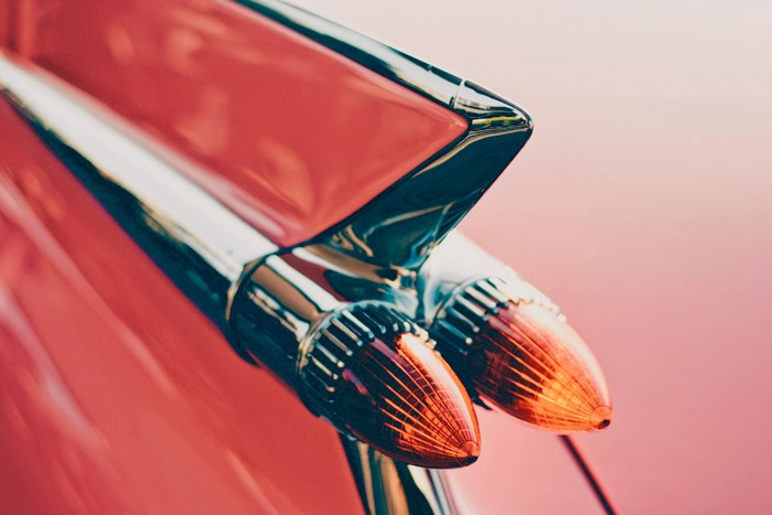 Close-up of a vintage red car's tail lights
