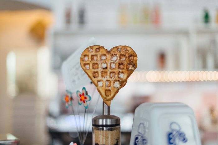 Heart-shaped waffle on a stick in a shop