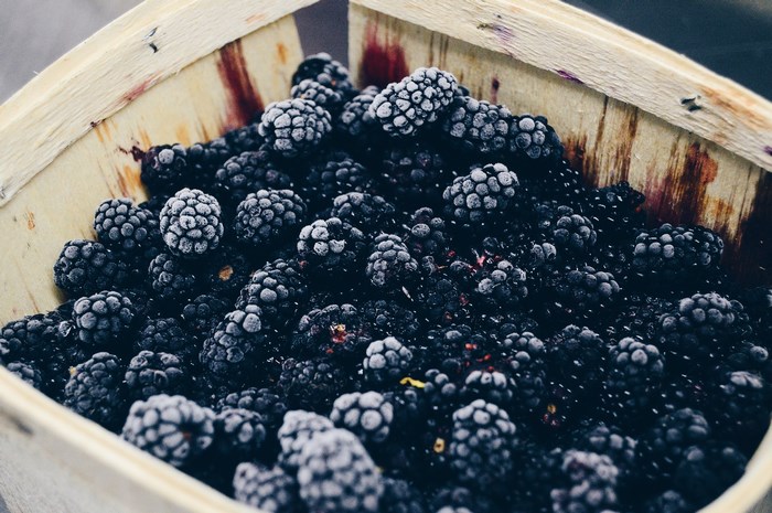 Frozen blackberries in a wooden basket