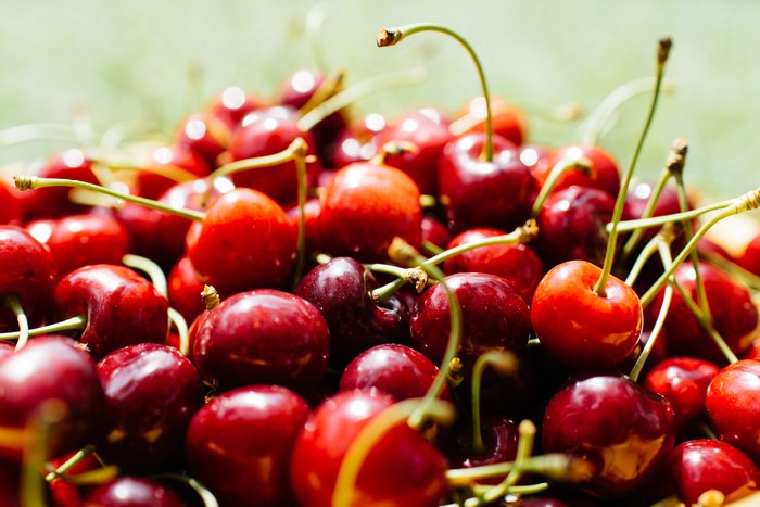 Close-up of fresh red cherries with stems
