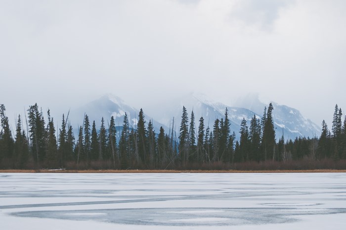 Frozen lake and misty mountains in Canada