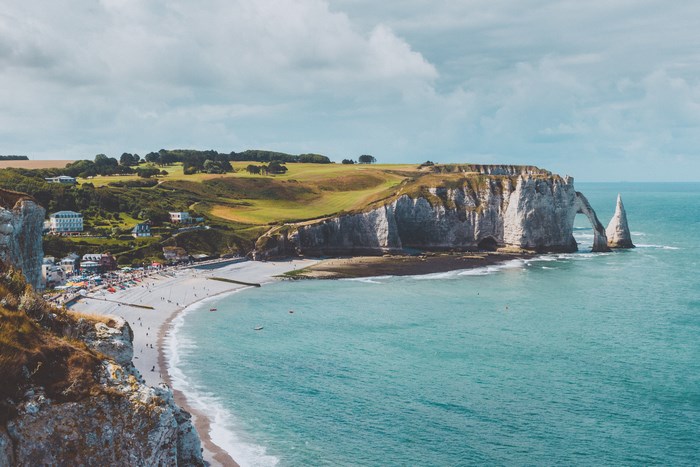 Etretat cliffs and beach with people and ocean