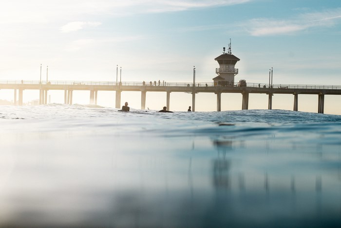 Surfers at Huntington Beach Pier at Sunrise