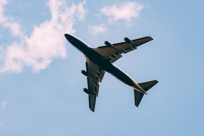 Passenger Jet Flying High in Clear Blue Sky