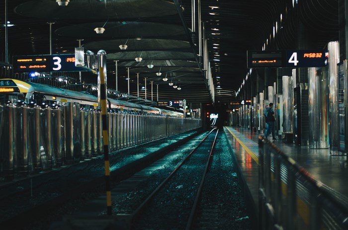 Train station platform with trains and signs