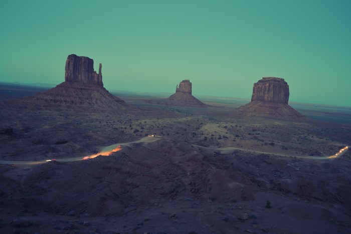 Monument Valley at Dusk with Cars on Road