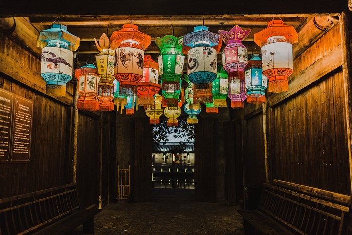 Colorful Chinese lanterns hanging in a wooden alleyway