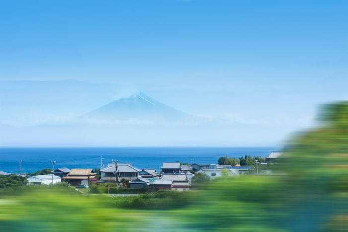 Mount Fuji over a coastal village in Japan