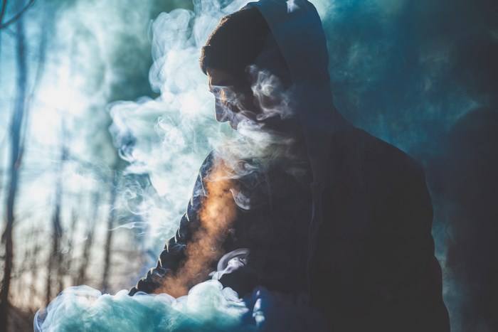 Man in smoke in a forest
