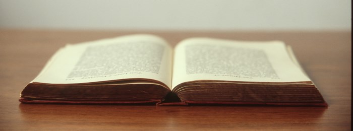 Open old book on a wooden table