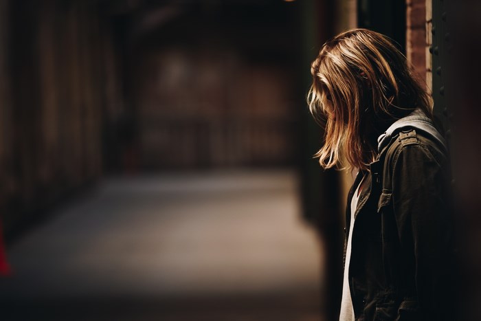 Woman in jacket in dark hallway