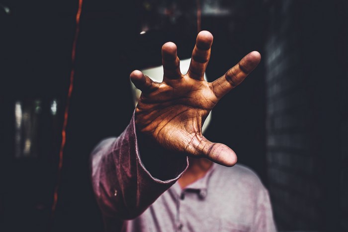 Person reaching out with their hand