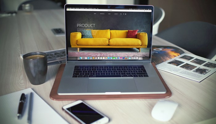 MacBook Pro displaying a product website with a yellow couch