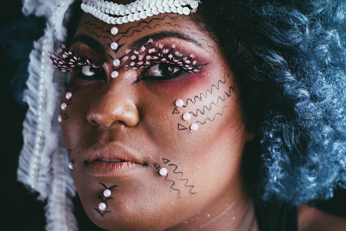 Woman with blue hair and tribal body art