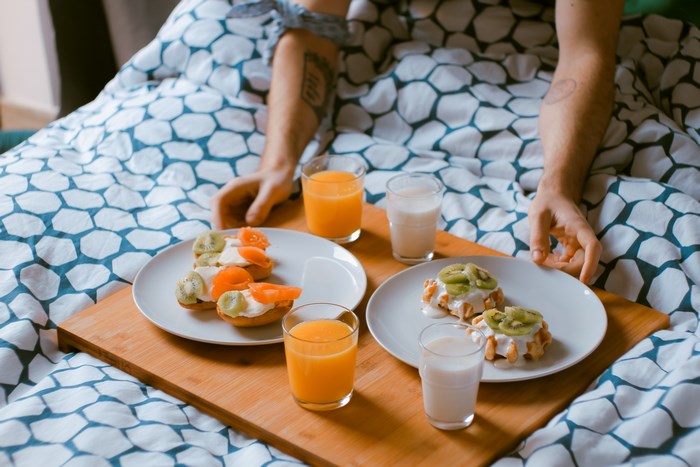 Breakfast in bed with orange juice and milk