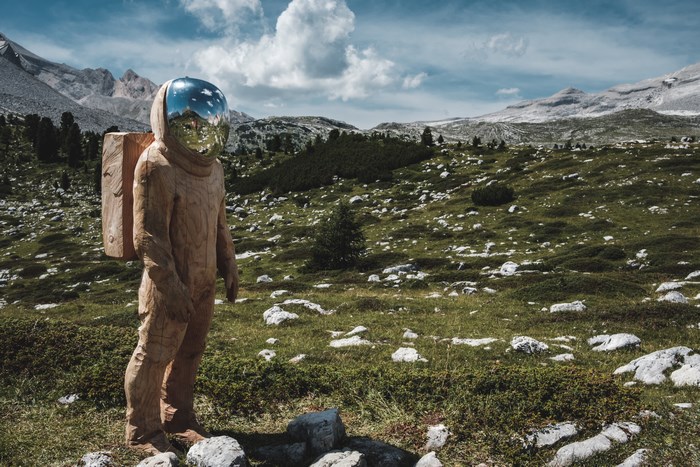 Astronaut sculpture in a rocky mountain landscape