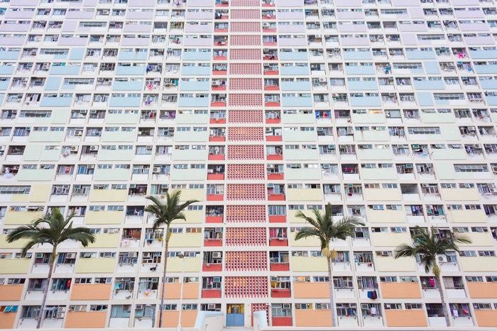 Colorful apartment building facade in Hong Kong with palm trees