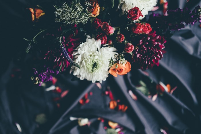 Dark floral bouquet with red and white flowers