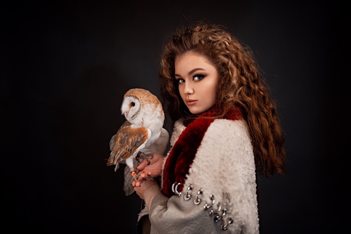 Woman holding a barn owl
