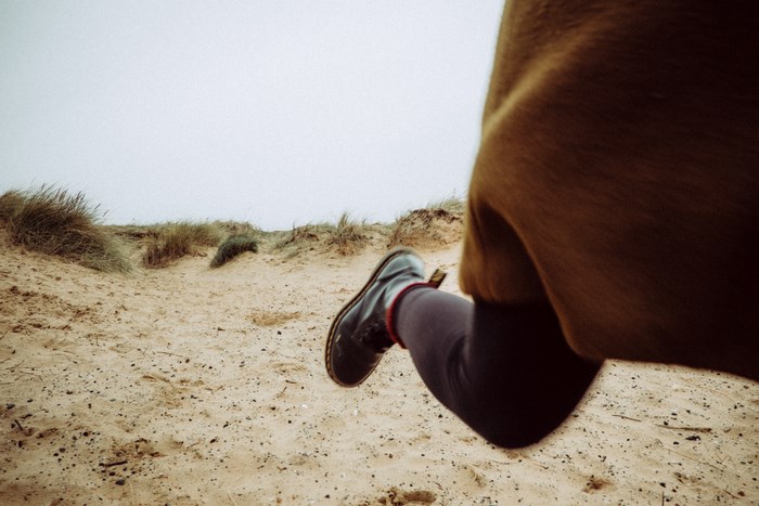 Person running on sand dunes