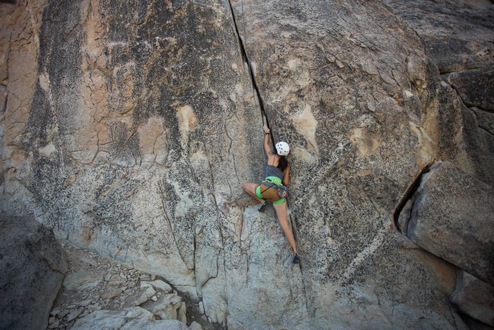 Woman climbing a rock face