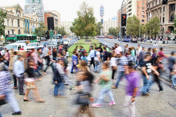 Busy city street with blurred pedestrians and traffic