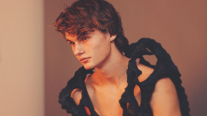 Male model wearing a black avant-garde outfit