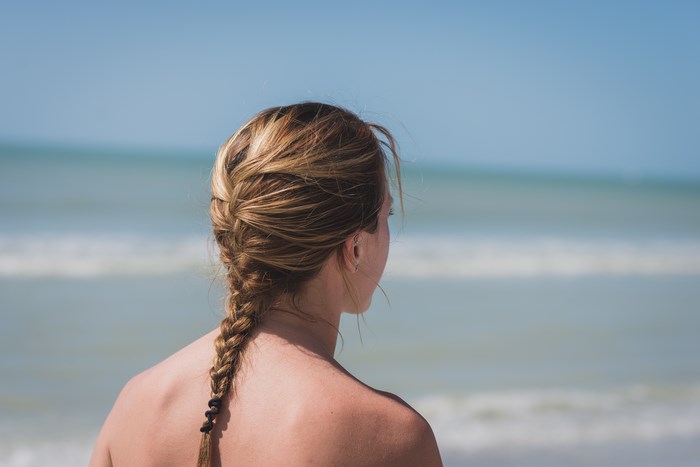 Blonde Woman with Braided Hair at Beach Shore