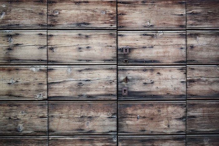 Aged wooden door with locks and knots