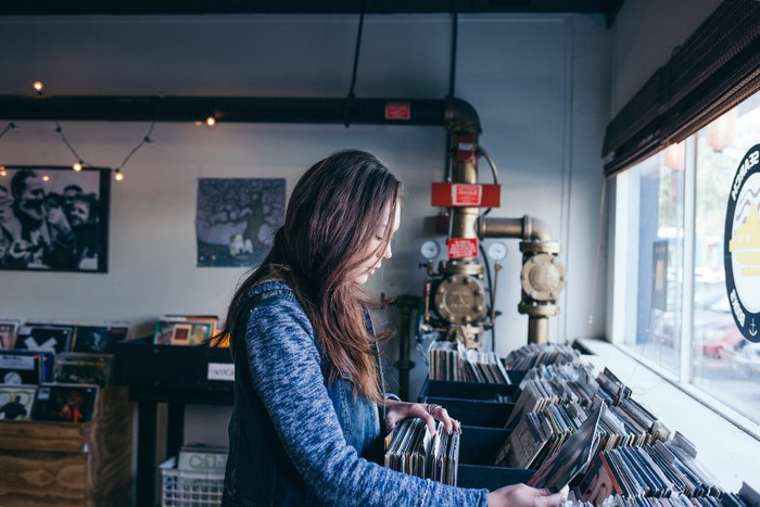 Woman browsing vinyl records in a store