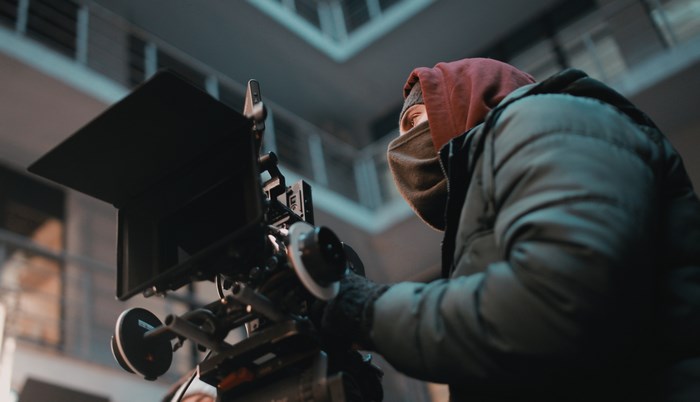 Man filming with professional movie camera