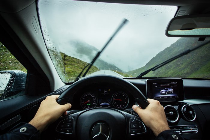 Mercedes dashboard driving on a rainy mountain road