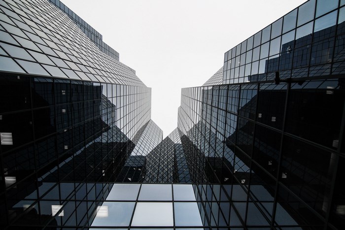 Modern glass skyscrapers reflecting the sky