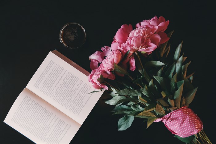 Pink Peonies, Open Book, and Coffee on a Dark Surface